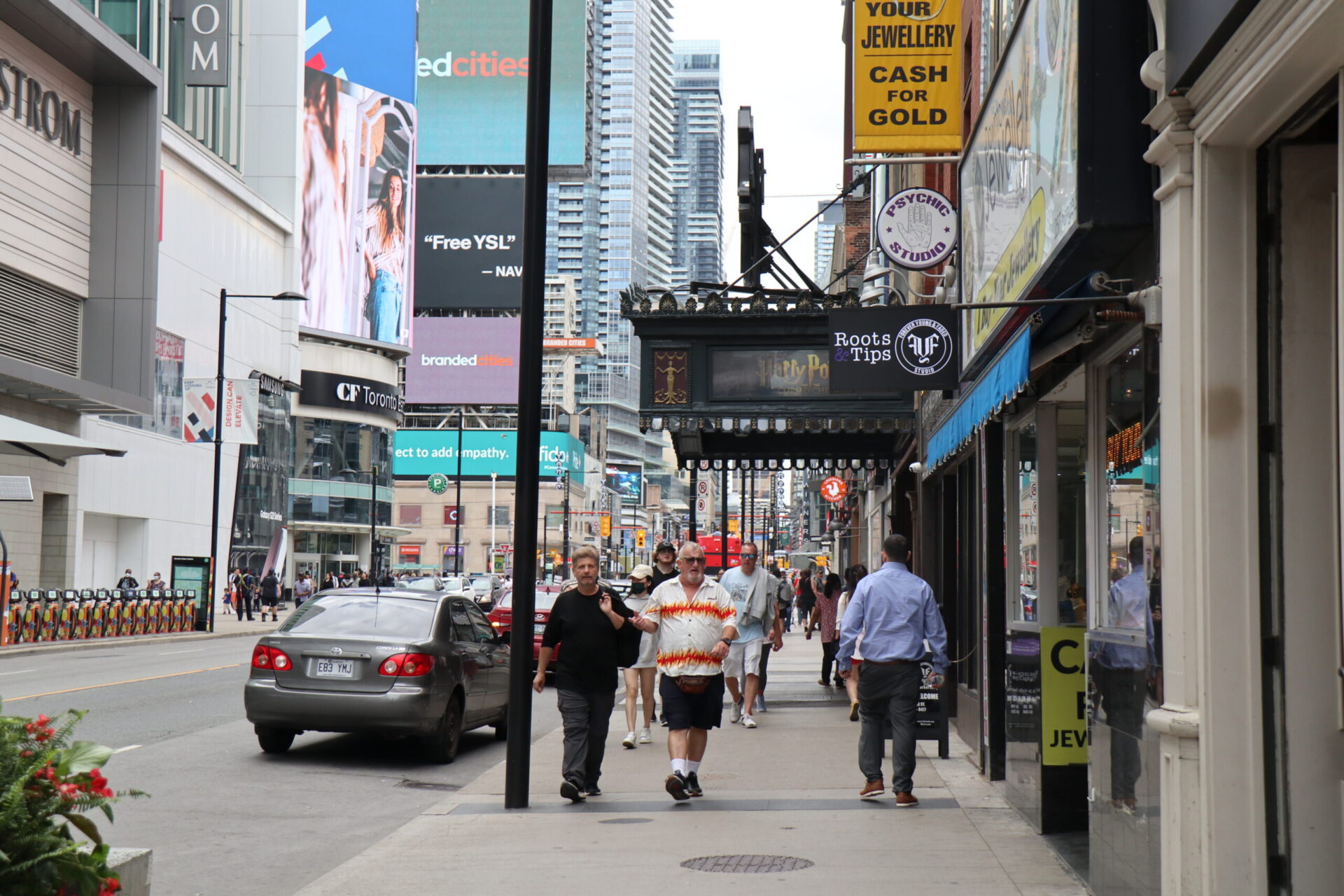 Yonge Street Looking North, Taken from South of Dundas. Pedestrians on sidewalk and cars on road.