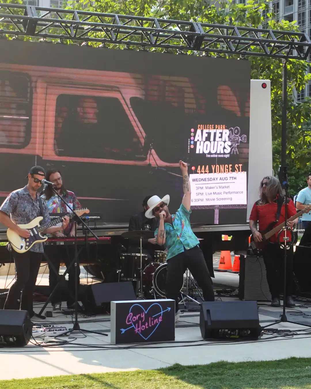 Crowd of people sitting in Muskoka Chairs.